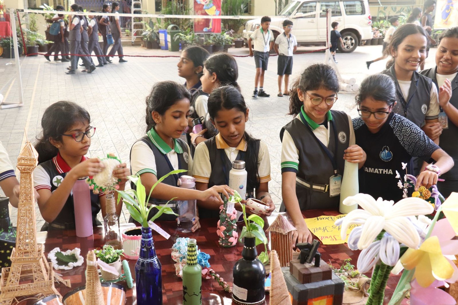 Students sharing their eco-friendly crafts at a school exhibition