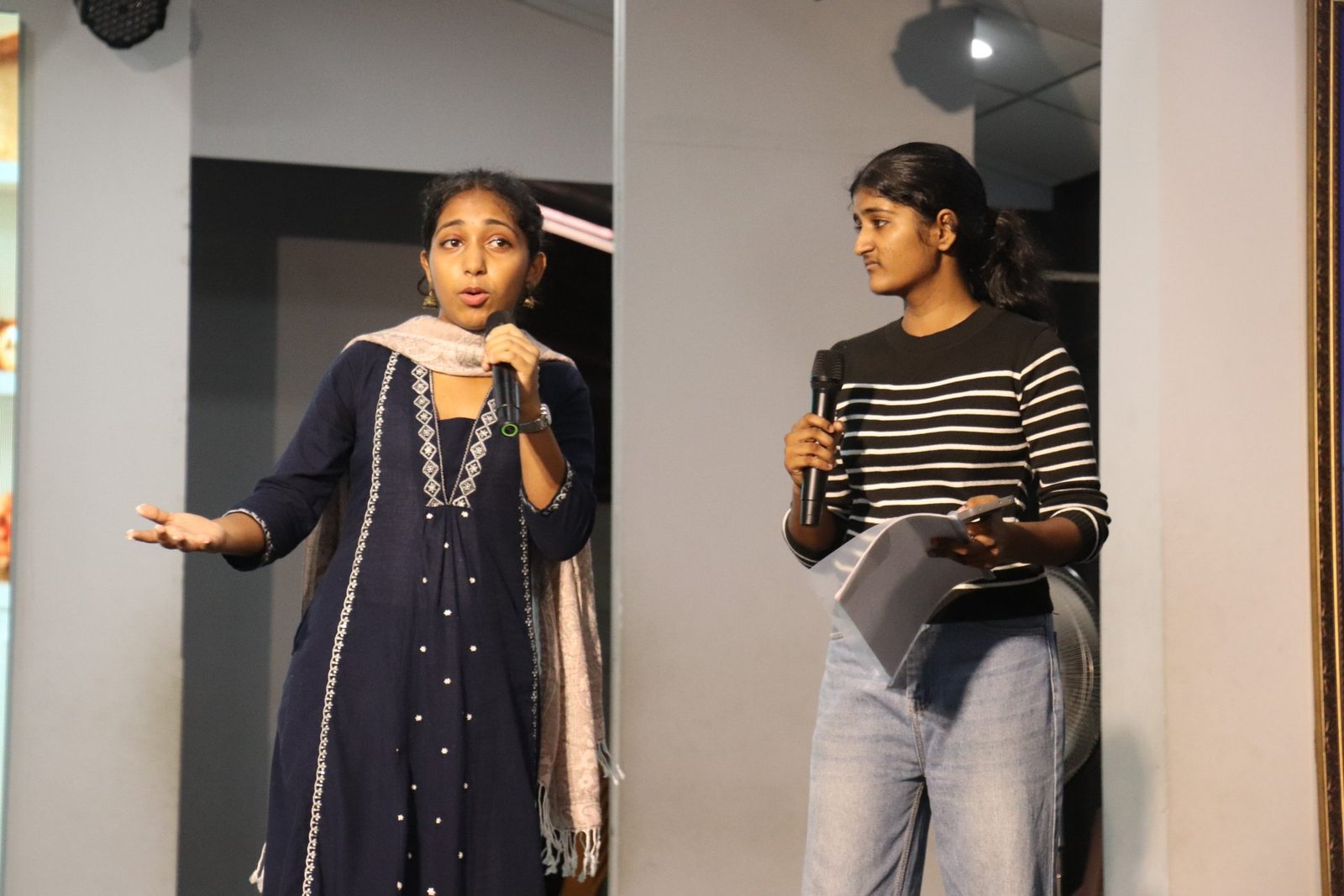 Students presenting together during an assembly
