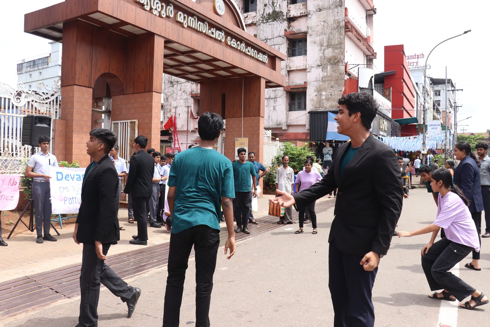 Students perform a street play for people near the municipal corporation