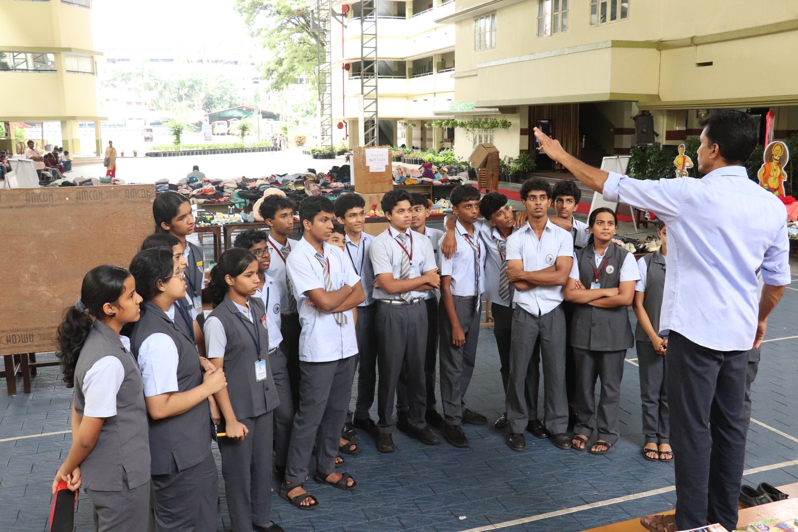 A teacher speaks with students at the community fair