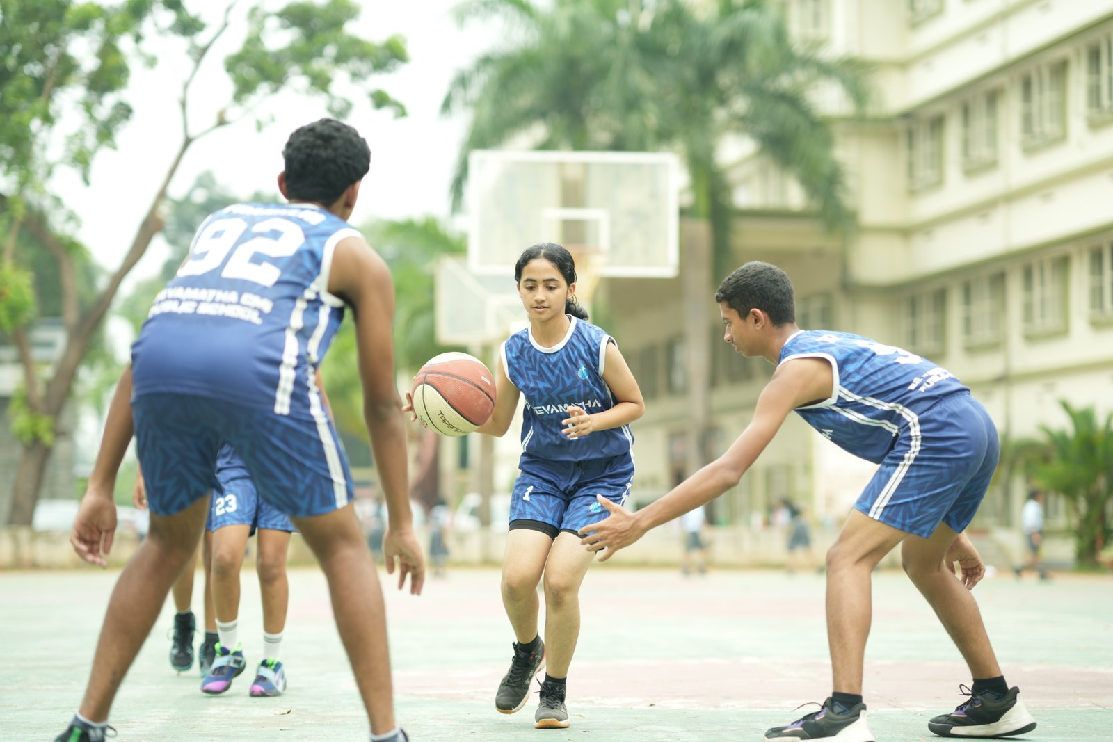 Students playing basketball together